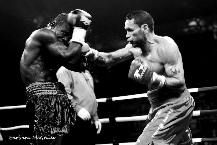 Black and white photo of a boxing fight, featuring Anthony Mundine.