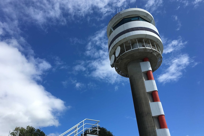 The air traffic control tower at Cairns Airport, as seen from the ground.
