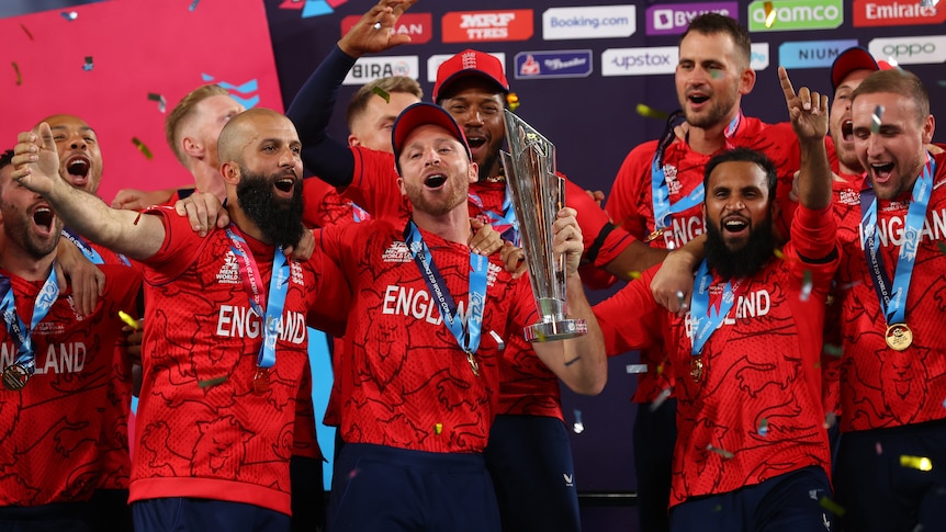 England players smile and hold a trophy