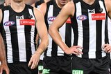 A tightly cropped image of Collingwood players in their black and white striped jerseys