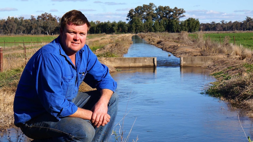Lachlan Valley Water chairman Tom Green standing at an irrigation channel at his farm near Forbes.