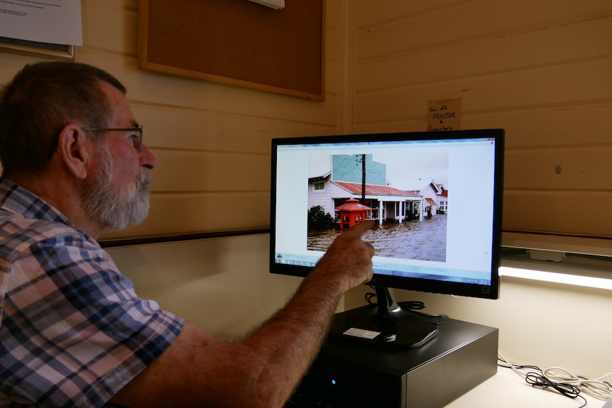 Phillip Bowman looking at computer screen.