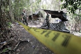 Security forces are seen at an abandoned camp in a jungle in Thailand