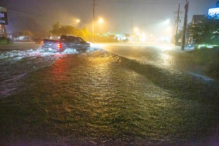 A ute navigates a flooded Gause Boulevard in Slidell, Louisiana