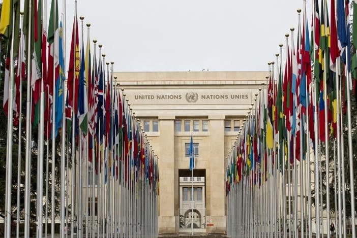 The united nations buildings with a row of flags