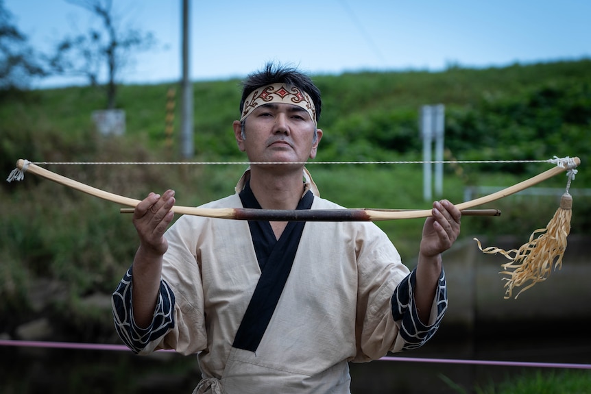 A man holds a bow 