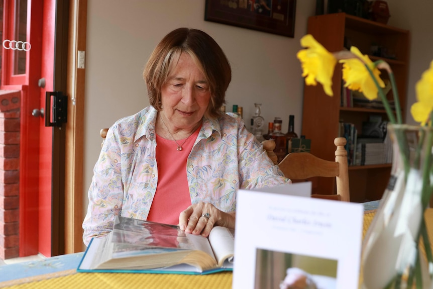 Frances Logan looks through a photo album.