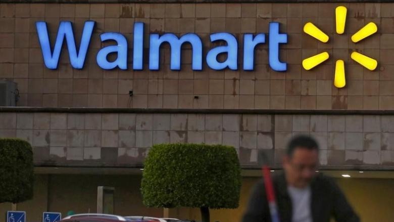 Man pushing trolley away from Wal-Mart store