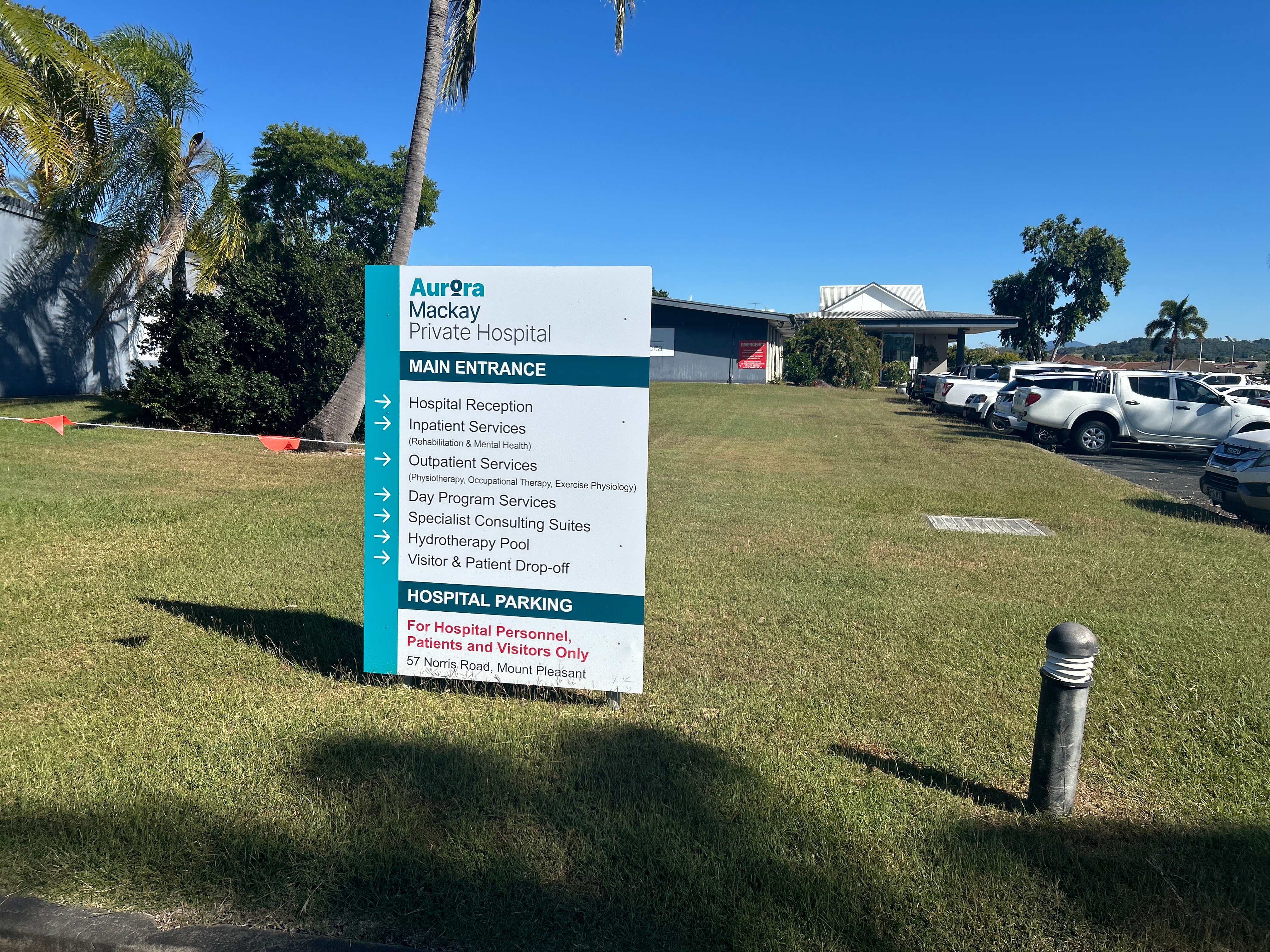A mackay private hospital sign, with the hospital building in the background
