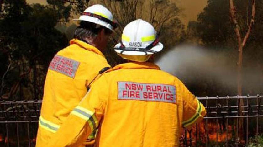 Rural Fire Service crew dousing flames.