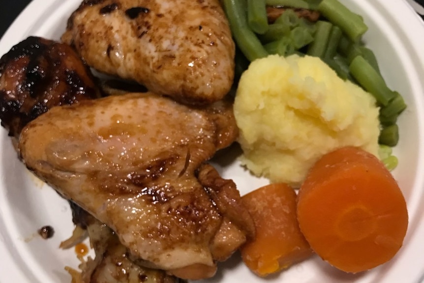 A roast chicken meal with vegetables.