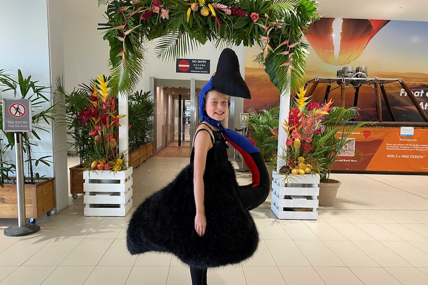 Eliza Ryan, 10, dressed as a cassowary at the Cairns Airport.