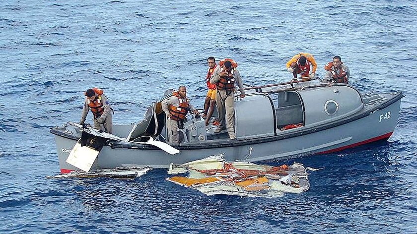 Crew members of the Brazilian frigate Constituicao recover debris.