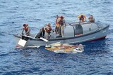 Crew members of the Brazilian frigate Constituicao recover debris.