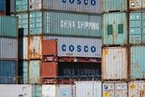 A huge stack of shipping containers bearing the logos of China Shipping and Cosco.