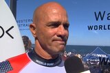 Kelly Slater looks emotional while speaking to a World Surf League interviewer.