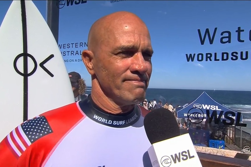 Kelly Slater looks emotional while speaking to a World Surf League interviewer.