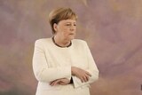 Angela Merkel crossing her arms.