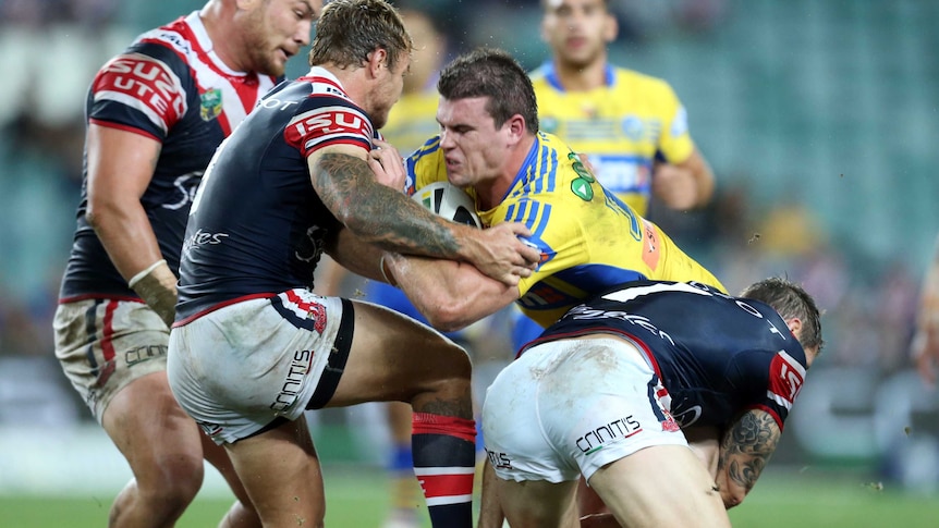 Darcy Lussick runs into Roosters defence