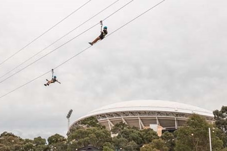 People on zip line with Adelaide Oval in background