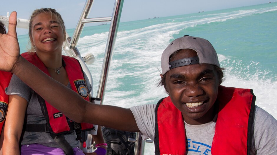 Jemima Wilson and Francis Yagan from the Kimberley desert community of Balgo Hills laughing on a boat.