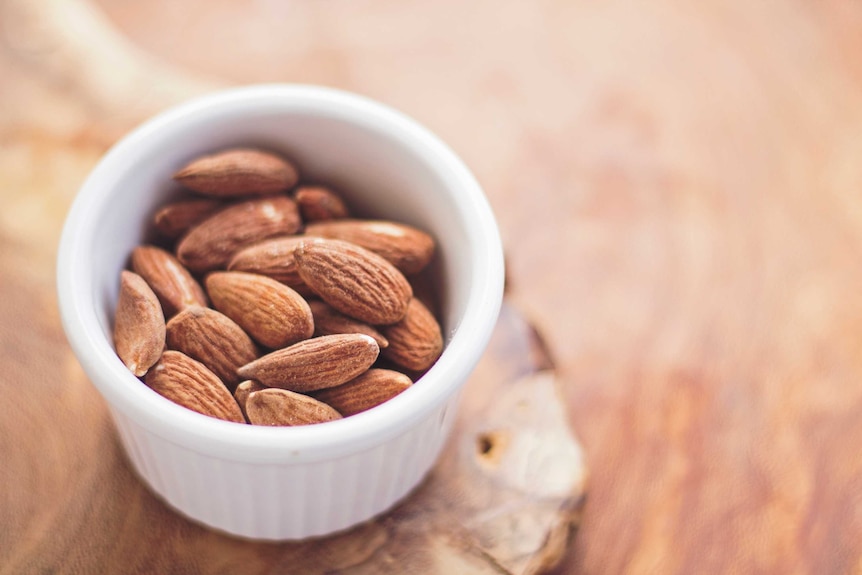 Closeup shot of a small bowl of almonds.