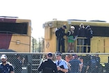 Police and railway staff cut two protesters free from the train at Tennyson.