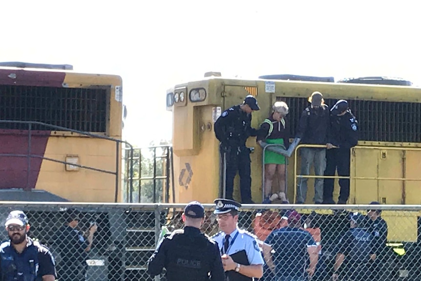 Police and railway staff cut two protesters free from the train at Tennyson.