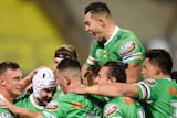 The Raiders surround Jarrod Croker as they celebrate his try against the Sharks.