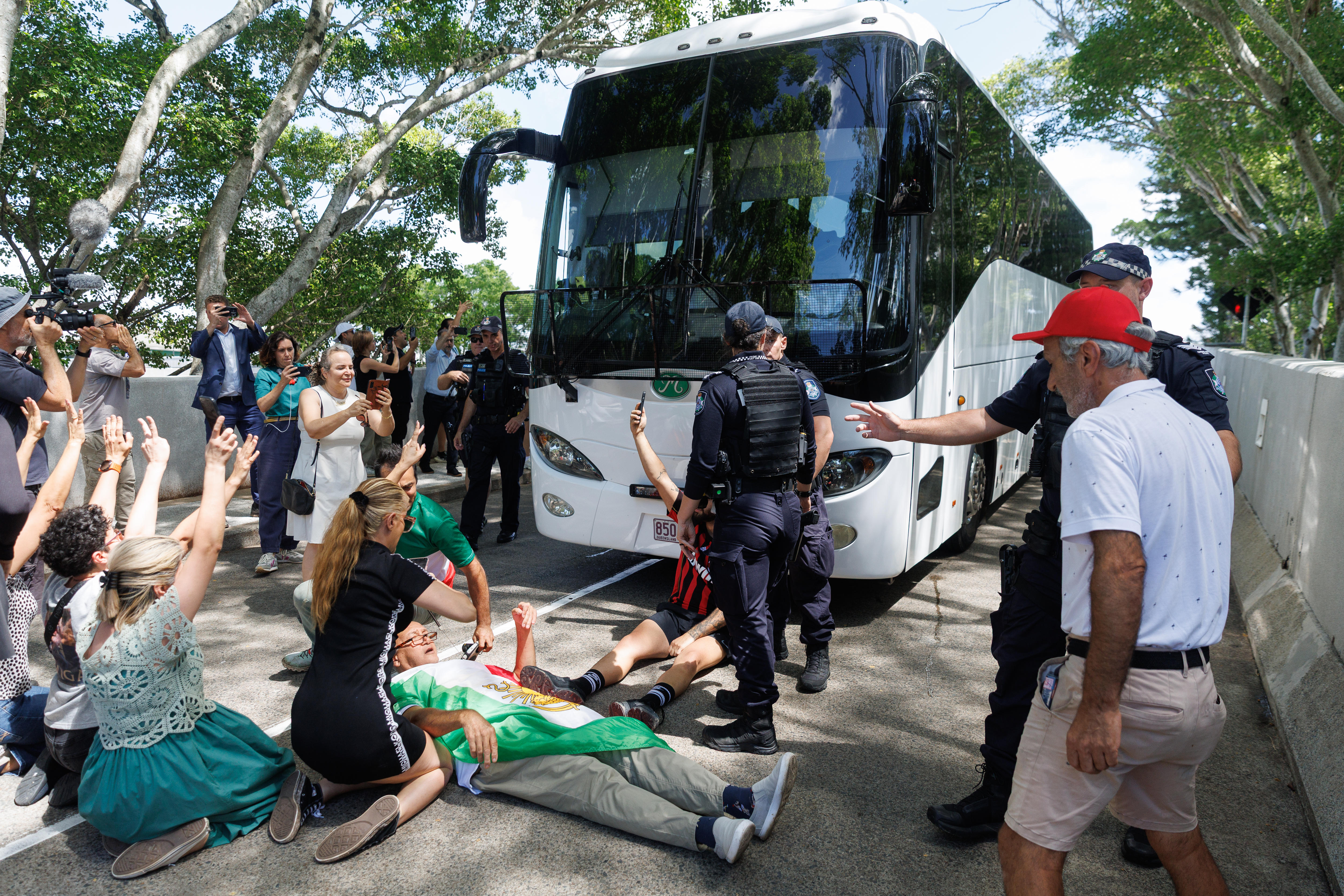 Protestors surround a bus