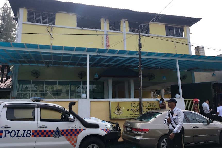 Police and fire authorities outside a school where there was a fire.