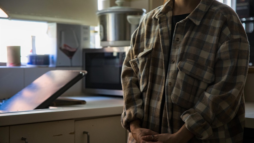 Alyssa standing in her kitchen.