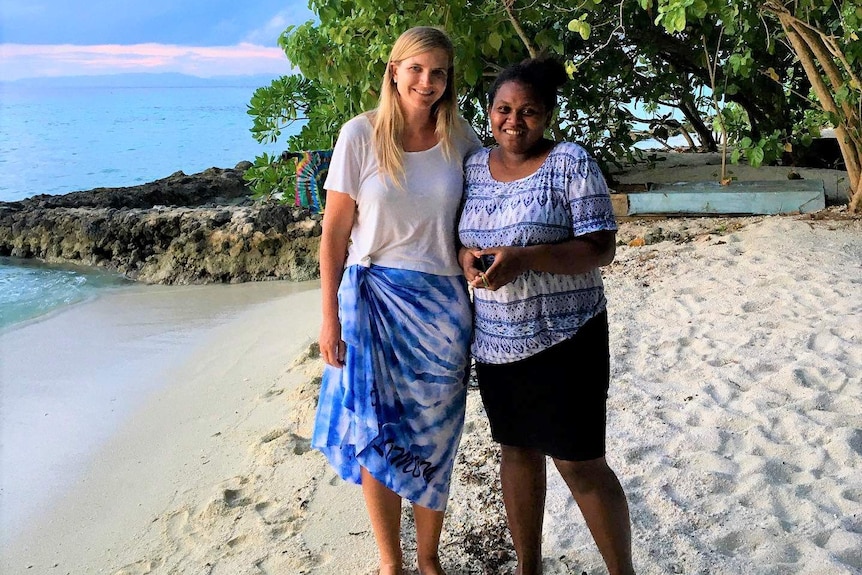 Australian woman on the left with arm around woman on right, who is a Solomon islander woman.