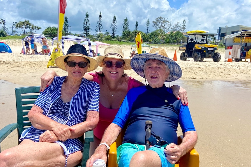 Three people at a beach