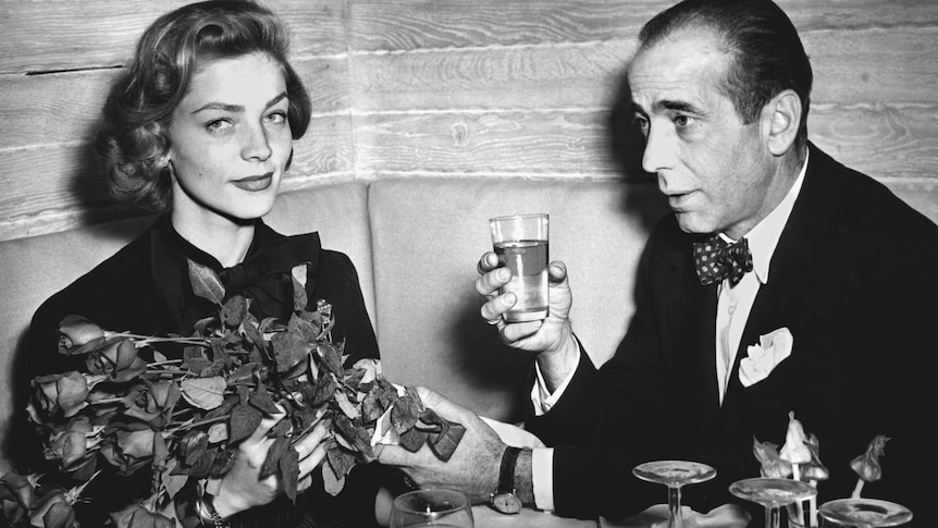 Lauren Bacall and Humphrey Bogart at a cocktail party