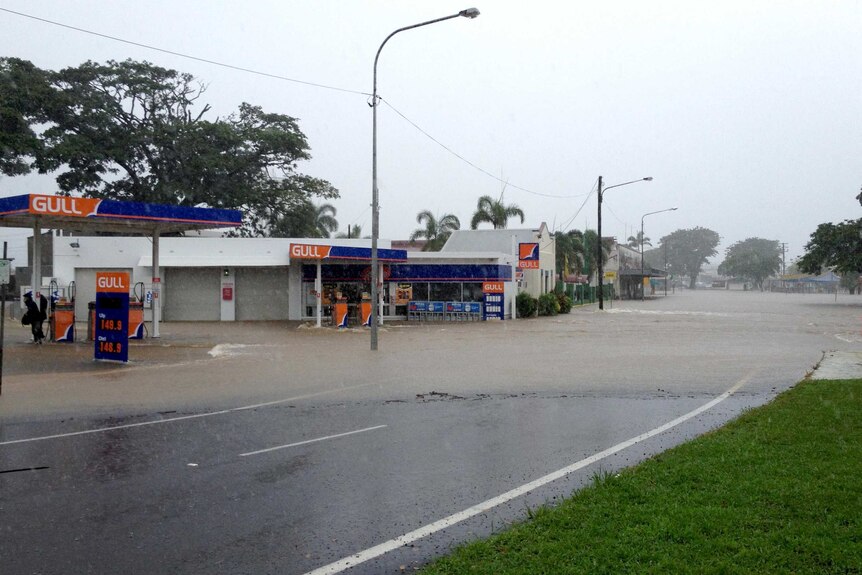 Floodwaters cover a road and buildings in the north Queensland town of Ingham.