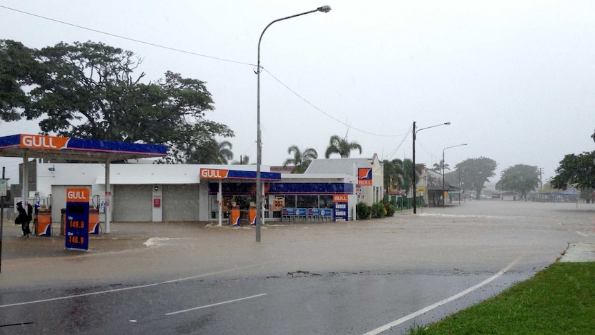 Floodwaters cover a road and buildings in the north Queensland town of Ingham.