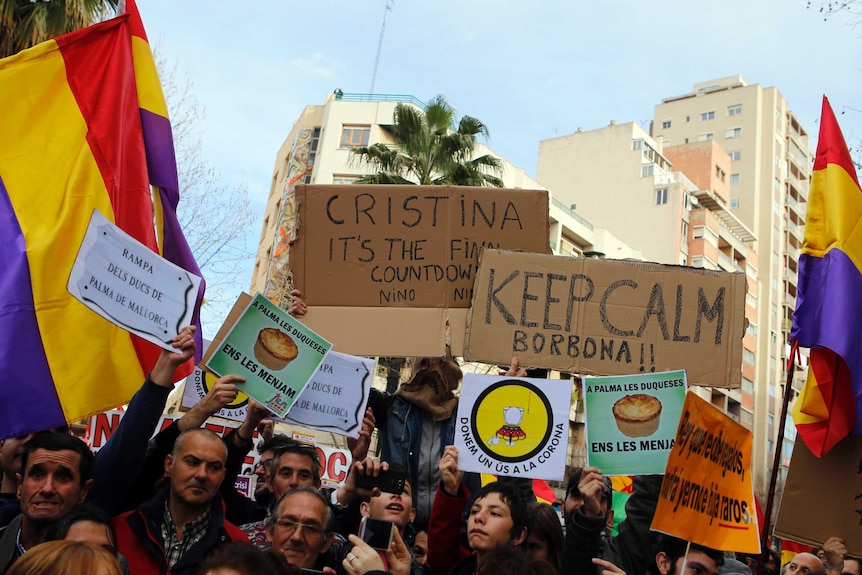 Protestors hold banners and republican flags as they gather near the courthouse where Spain's Princess Cristina is testifying.