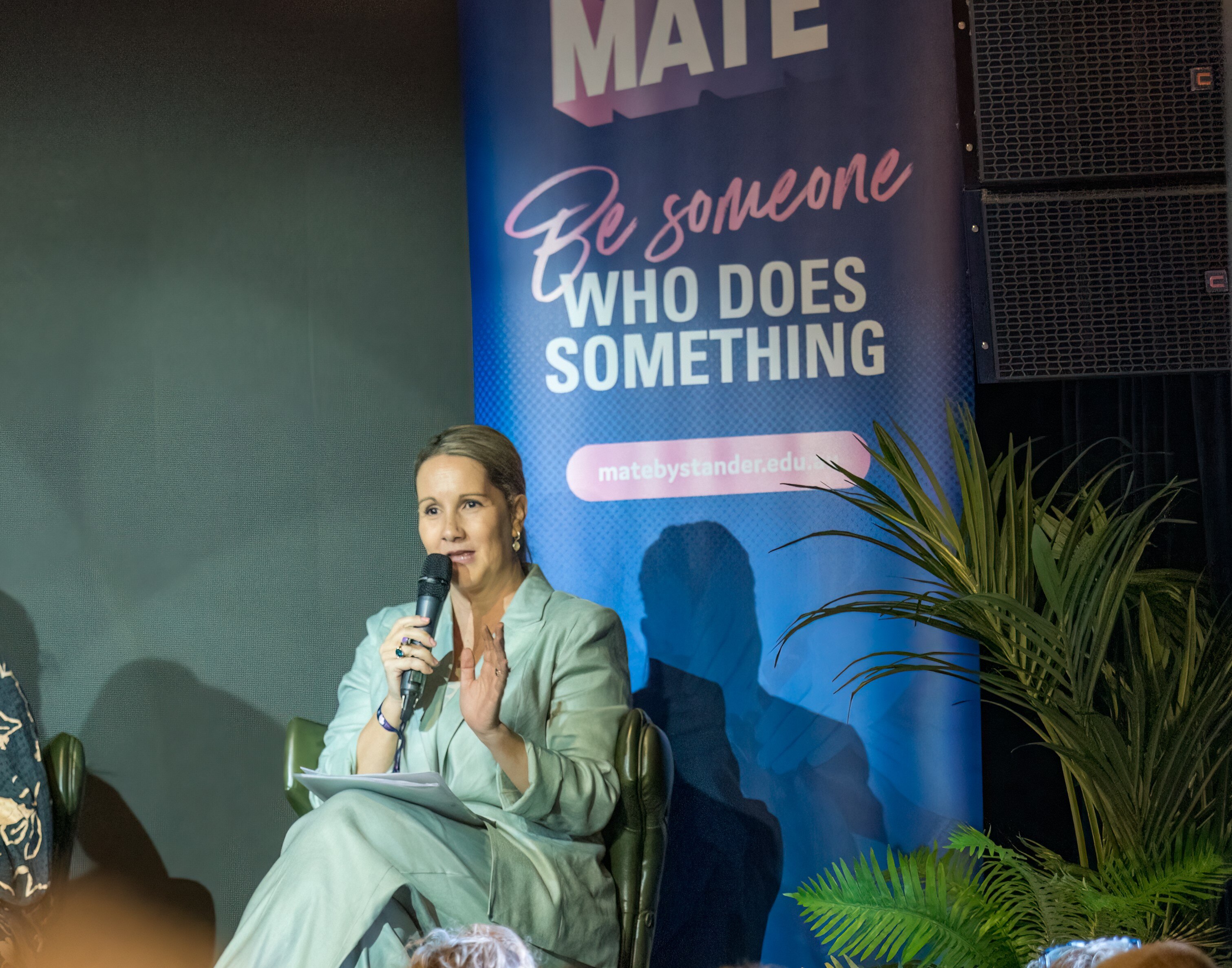 A woman speaking at a conference.
