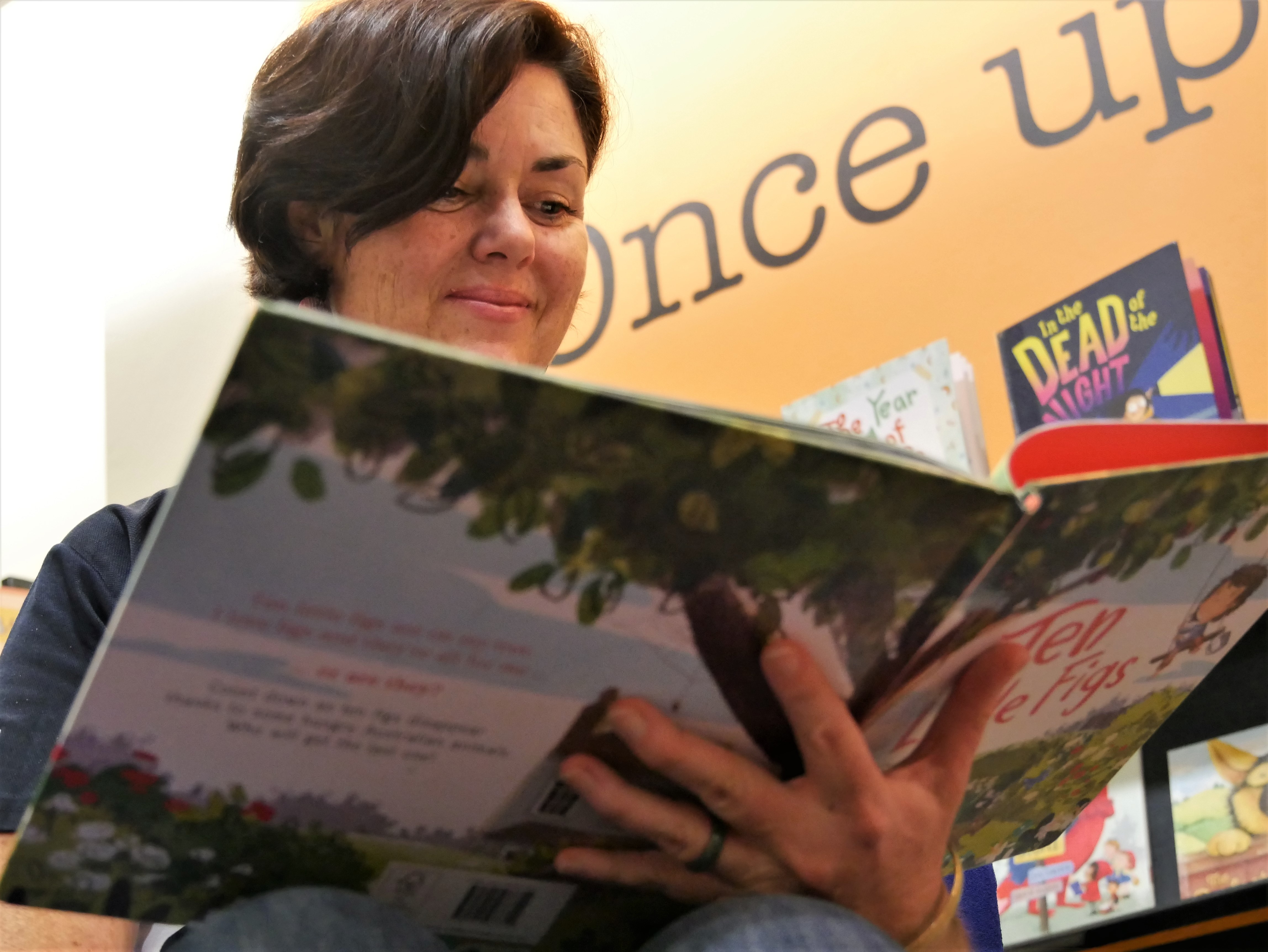 woman reading book from below