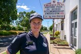 Sergeant Julia Henderson smiles outside the Emerald PCYC building in her Queensland Police Service uniform