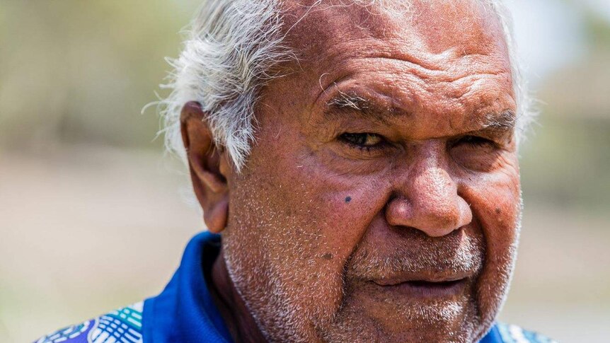 A close up photo of a man looking concerned.