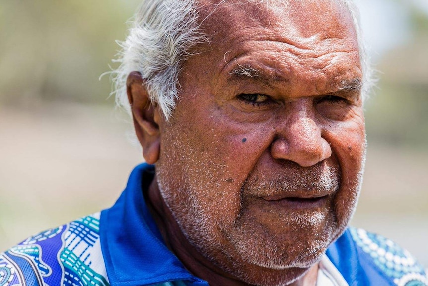 A close up photo of a man looking concerned.