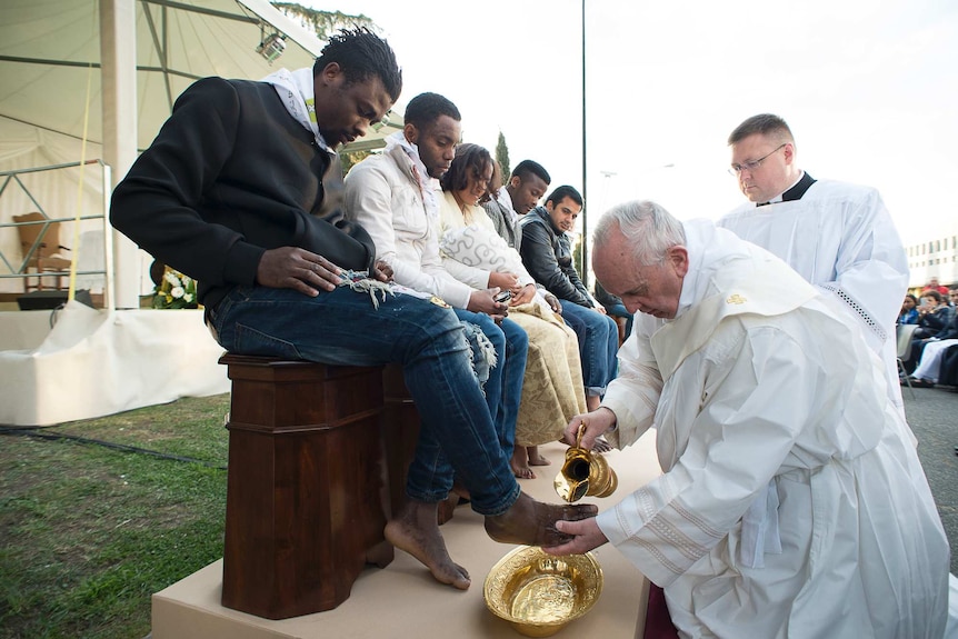 Pope Francis performs a traditional foot-washing ritual on Holy Thursday
