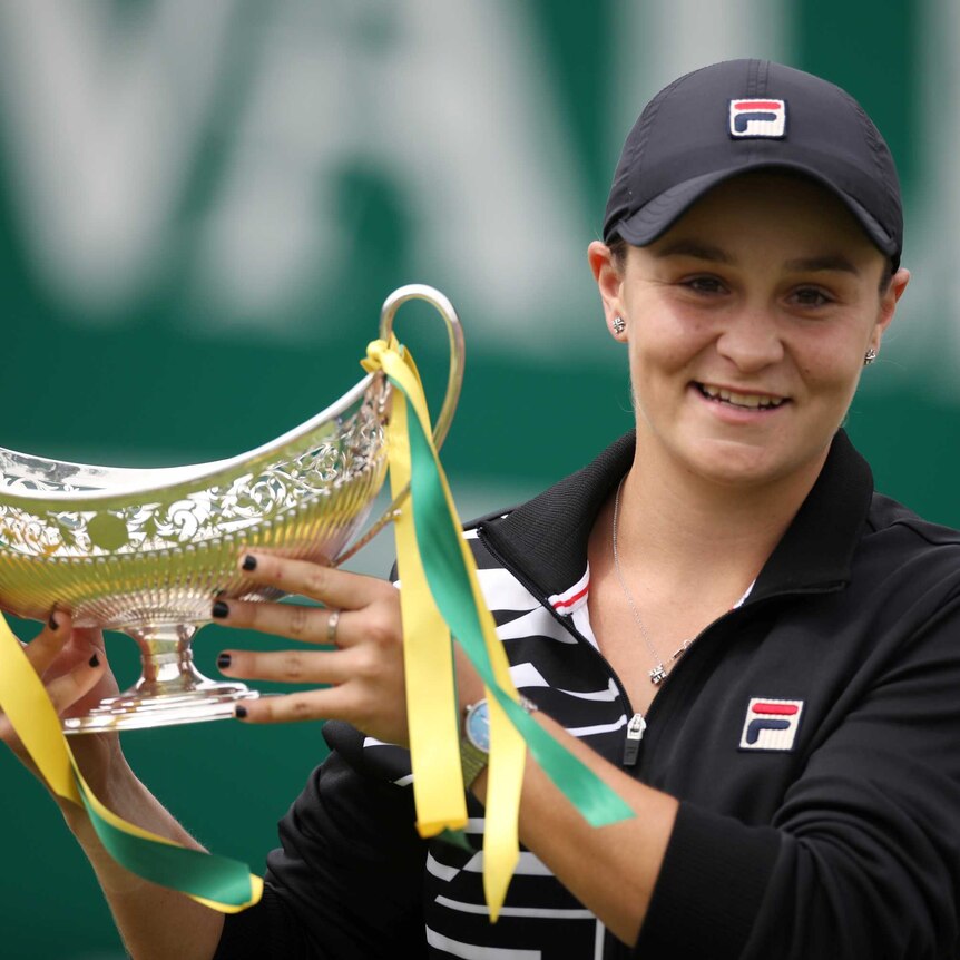 Ashleigh Barty holds up the Birmingham final trophy.