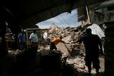 People clean up after an earthquake struck off the southern coast of Mexico.