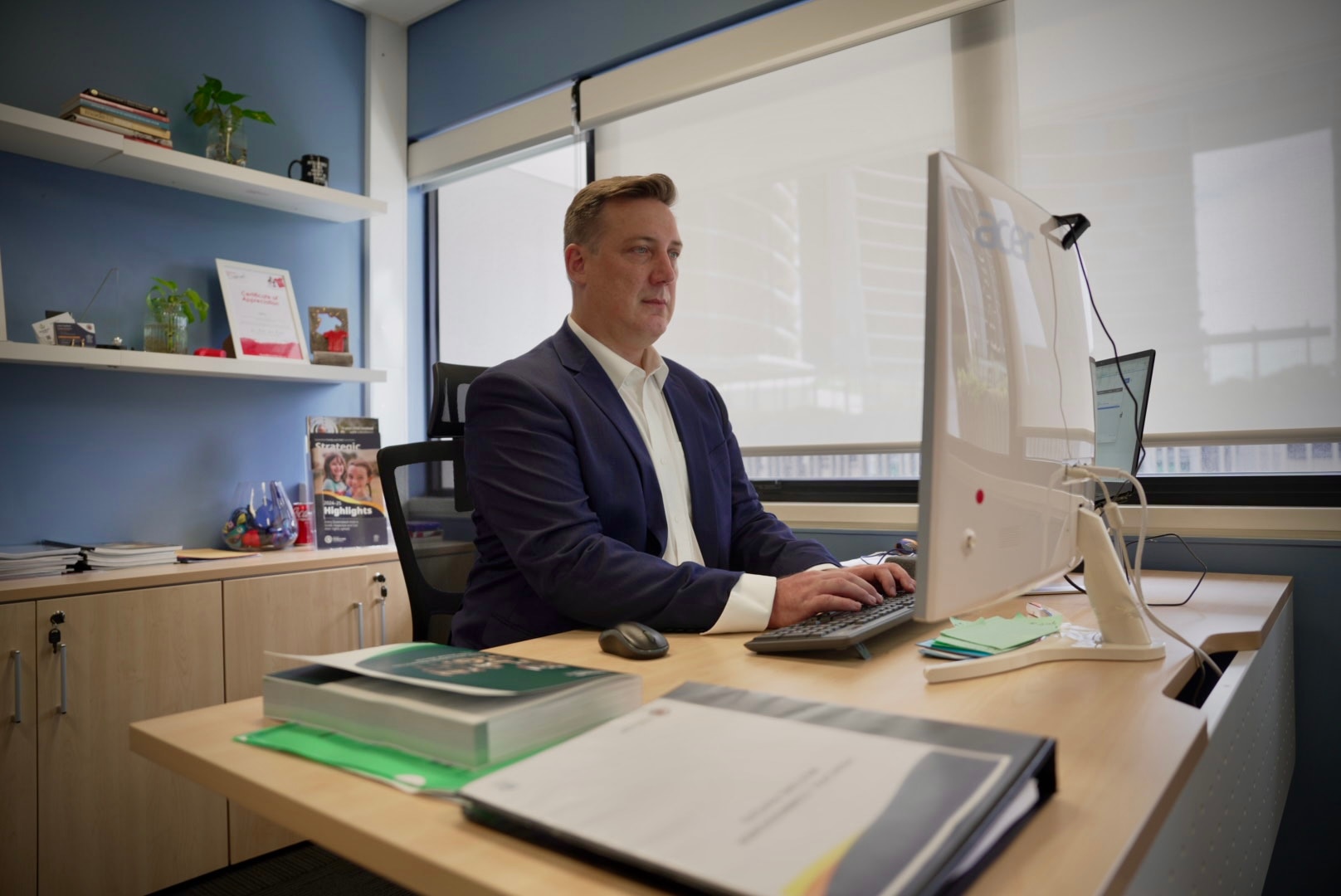 A suited man at a desk