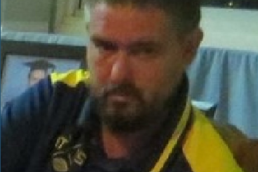 A man with a beard wearing a polo shirt