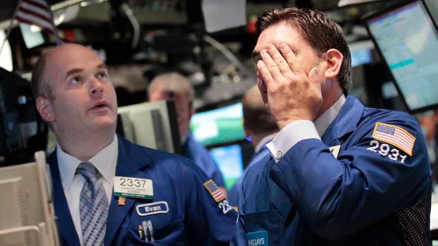 Stressed traders work on the floor of the New York Stock Exchange