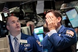 Stressed traders work on the floor of the New York Stock Exchange